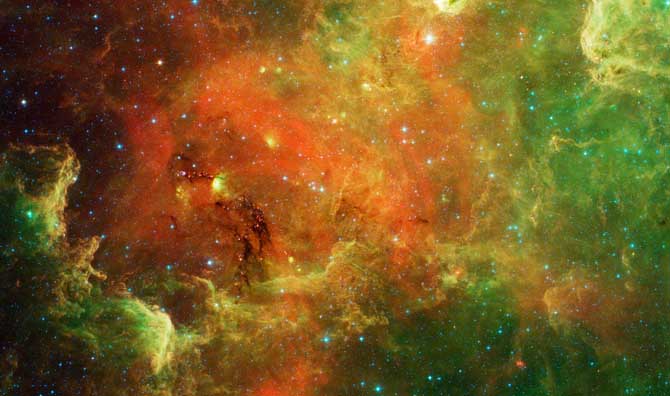This swirling landscape of stars is known as the North America nebula. In visible light, the region resembles North America, but in this new infrared view from NASA's Spitzer Space Telescope, the continent disappears. north america spitzer 670 Astronomy Picture of the Day