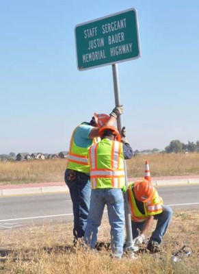 Completing the dedication, CDOT crews put up the new sign